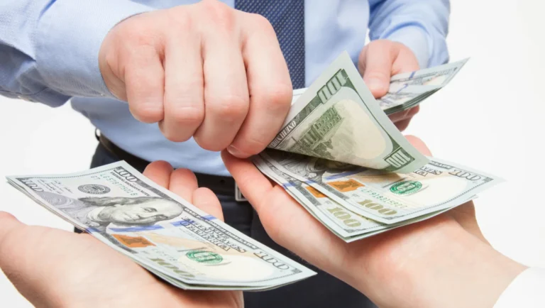 North Cyprus minimum wage increase - hands counting Turkish Lira banknotes representing the new 44,546 TL net salary
