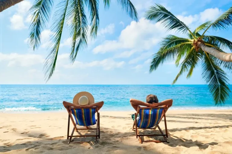 Two beach chairs on pristine Cyprus beach with palm trees and crystal clear turquoise water - perfect Cyprus vacation destination